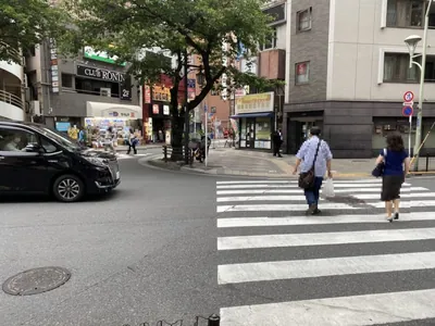 日暮里　ミダスへの道順 5／7：道なりに右折すると左手に原田建設不動産という不動産屋さんが出てくるので横断歩道を渡ります。
